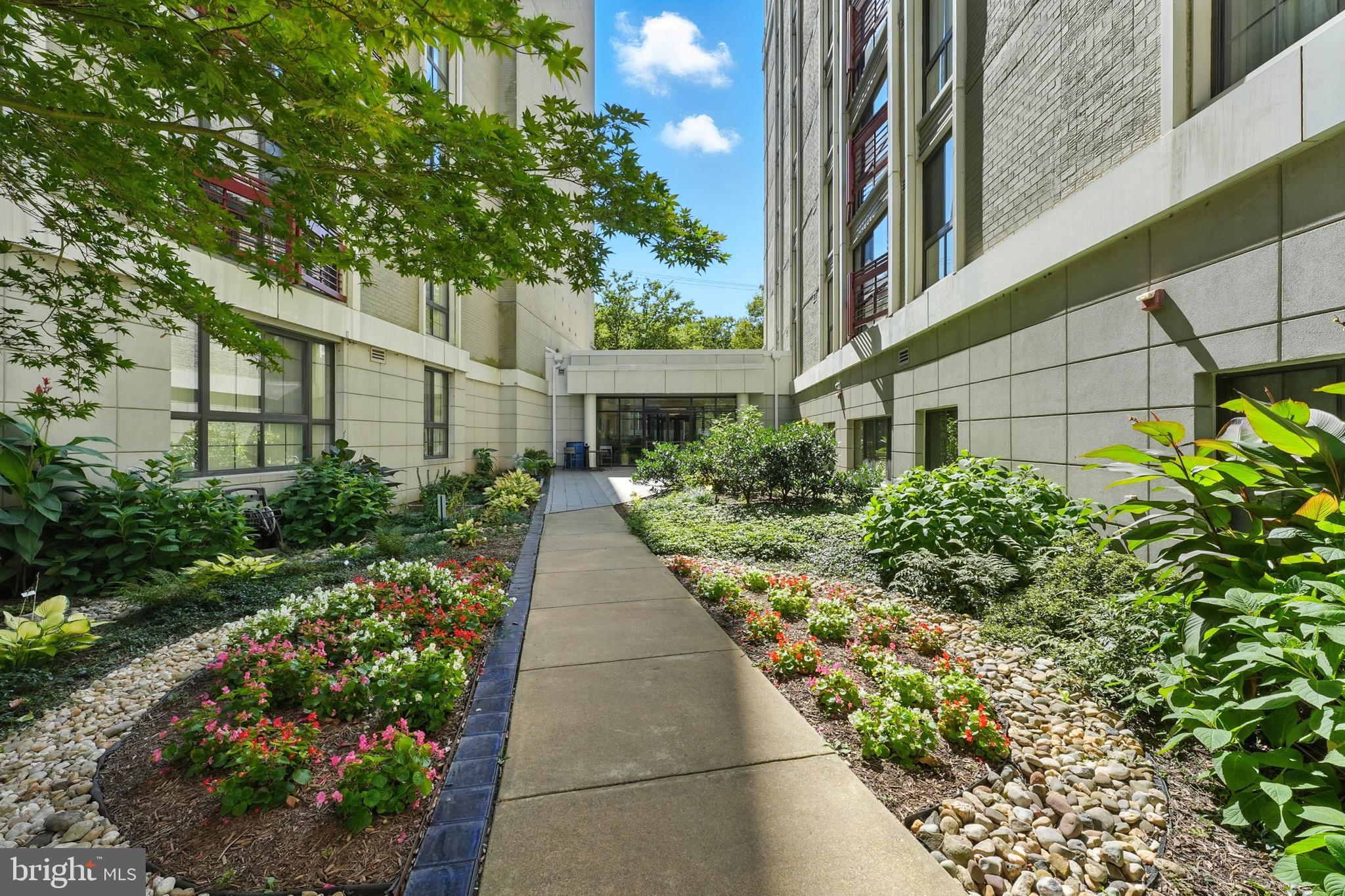 7923 Eastern Avenue Northwest, Unit 303 Silver Spring, MD 20910 - Photo 36 of 38 a view of a pathway with house on both side