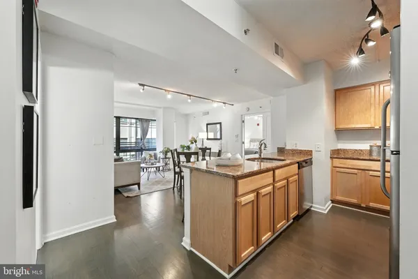 a kitchen with sink stove and refrigerator