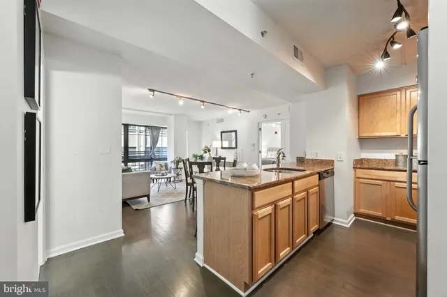 a kitchen with sink stove and refrigerator