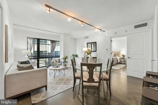 a dining room with furniture and wooden floor