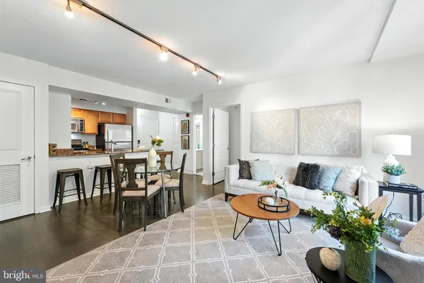 a living room with furniture a window and a table