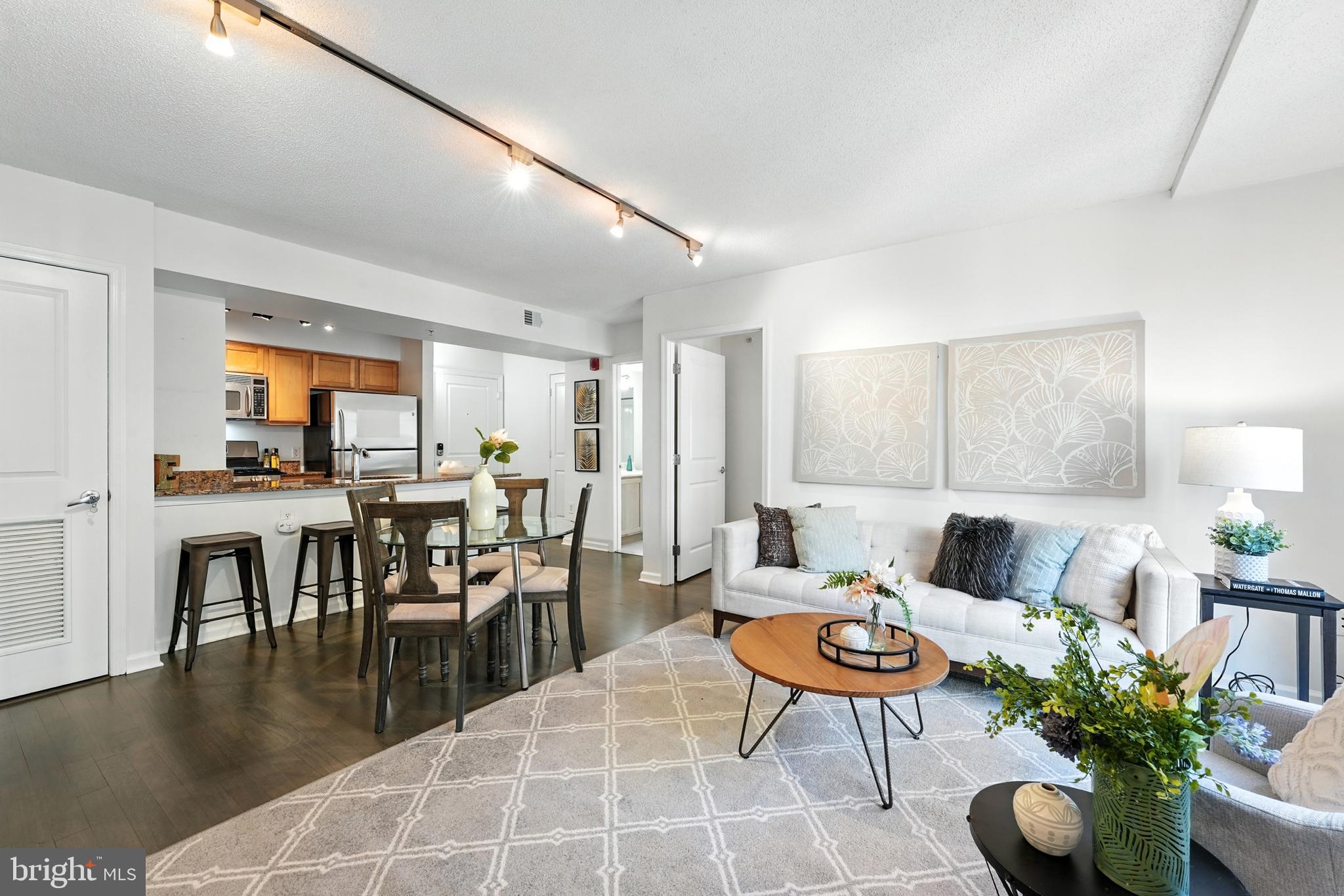 7923 Eastern Avenue Northwest, Unit 303 Silver Spring, MD 20910 - Photo 10 of 38 a living room with furniture a window and a table