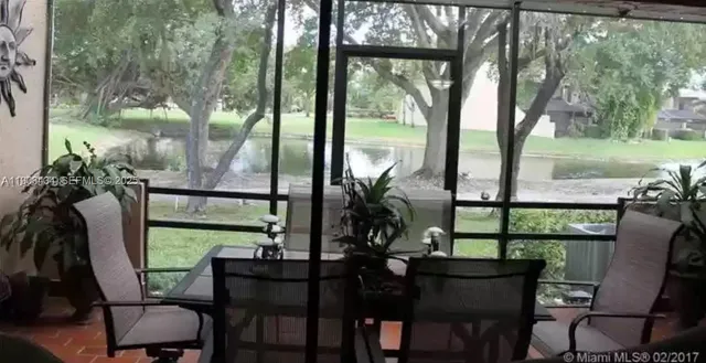 a view of a porch with furniture and a yard