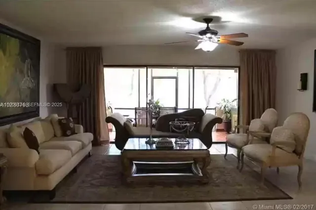 a living room with furniture and a large mirror