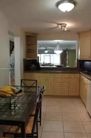 a kitchen with a table and chairs in it