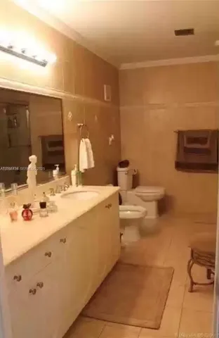 a bathroom with a double vanity sink toilet and mirror