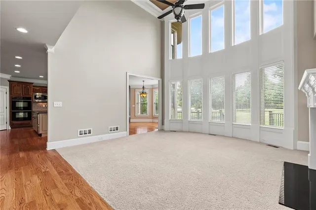 a kitchen with stainless steel appliances kitchen island granite countertop a refrigerator and a stove top oven