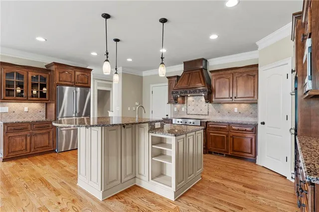 a kitchen with stainless steel appliances granite countertop a stove and a refrigerator