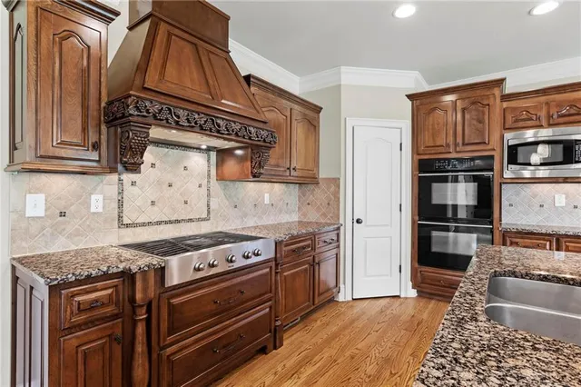 a view of an empty room with wooden floor fireplace and a window