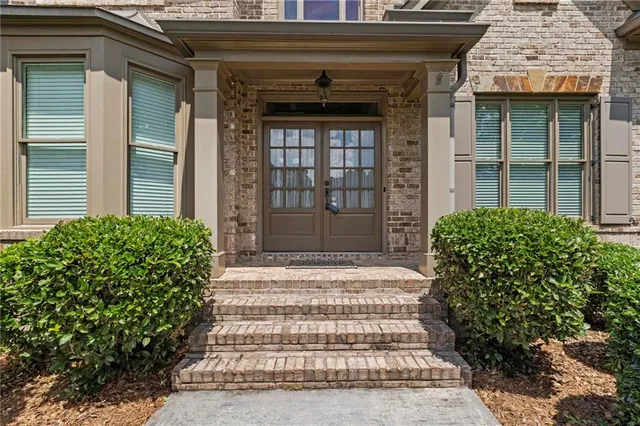 a front view of a house with a garden