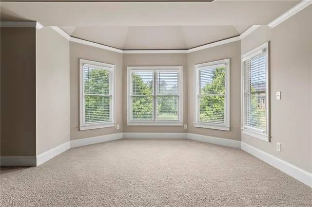 an empty room with a window and a ceiling fan