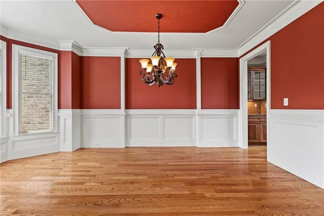 a view of a kitchen with furniture and wooden floor