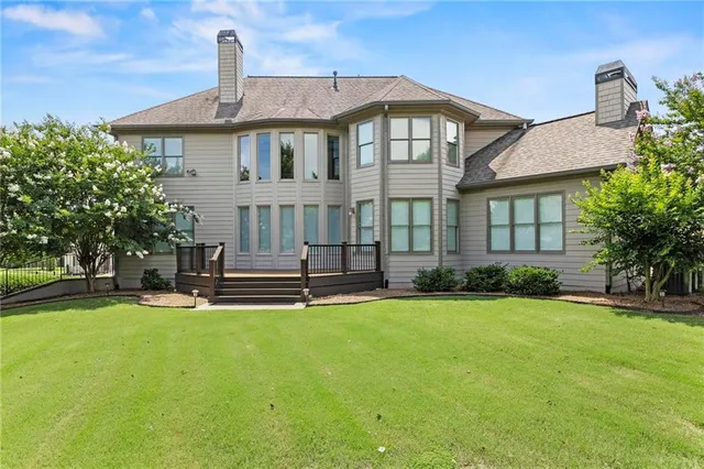 a front view of a house with a yard and potted plants