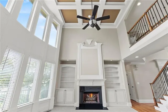 a view of an empty room with a fireplace and a window