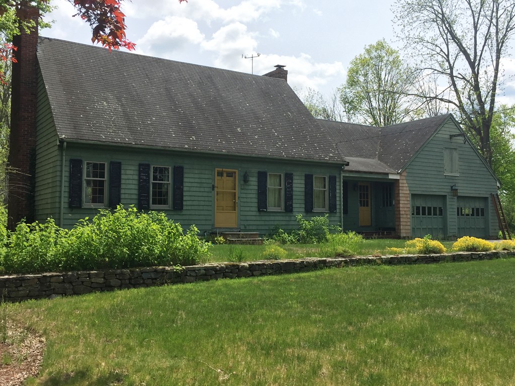 134 Pelham Island Road Wayland, MA 01778 - Photo 1 of 4 a front view of a house with a yard table and chairs