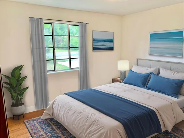 a bedroom with a large bed and a window