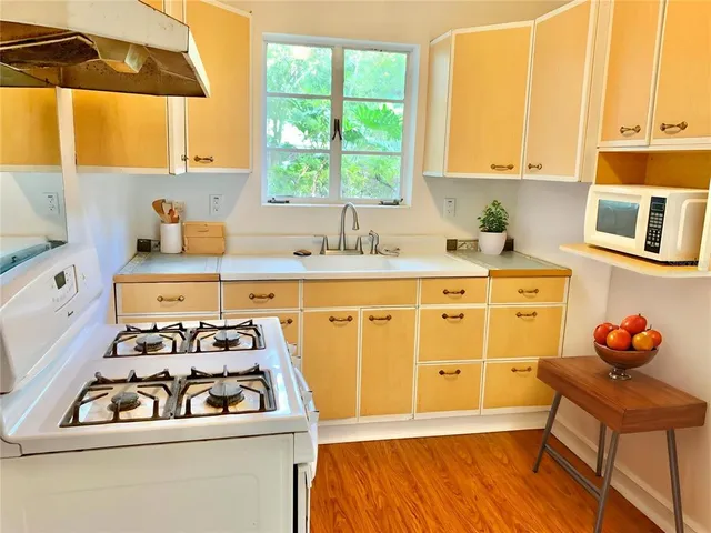 a kitchen with stainless steel appliances a stove a sink and a refrigerator
