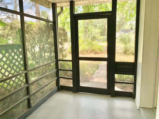 a view of an empty room with a large window with outer view