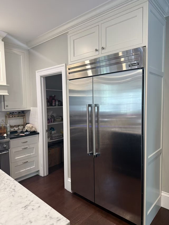 15 Cedar Road Brookline, MA 02467 - Photo 5 of 26 a kitchen with a refrigerator and a stove top oven