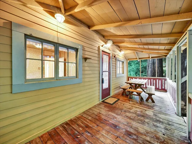 a view of a patio with table and chairs with wooden floor