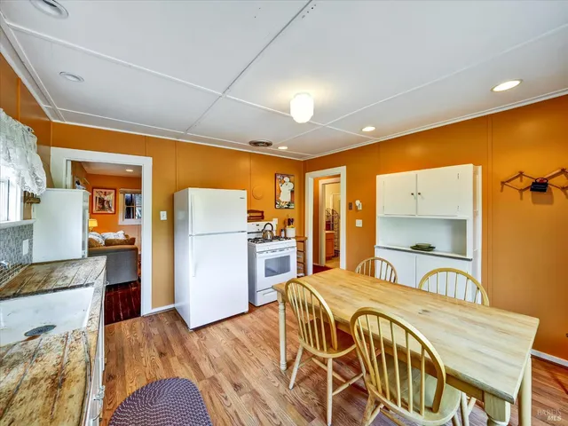 a bedroom with a bed and a large mirror with a wooden floor