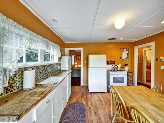 a kitchen with stainless steel appliances granite countertop a sink and wooden cabinets