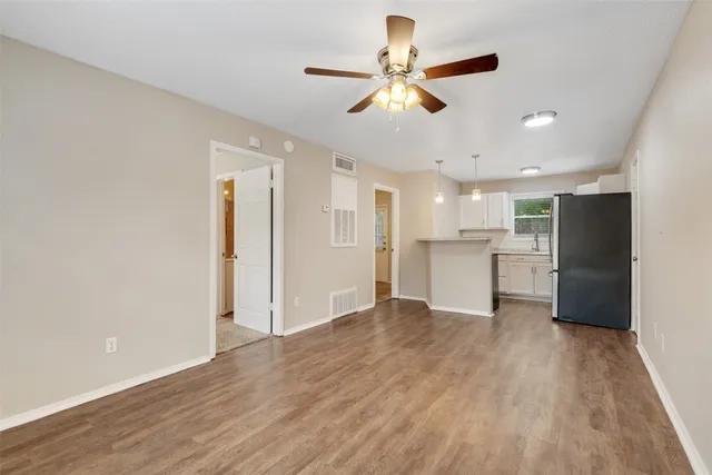 a view of a kitchen with a dishwasher cabinets and wooden floor