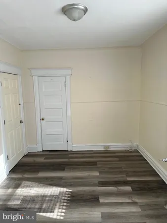 a view of a room with wooden floor and a window