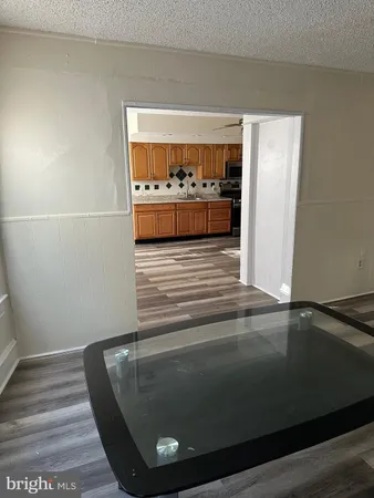 a metallic refrigerator freezer sitting in a kitchen
