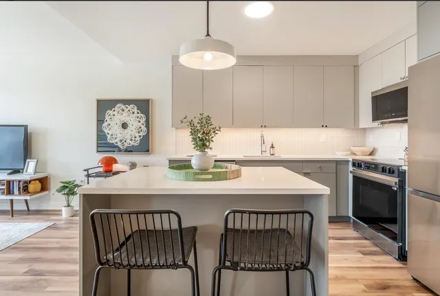 a kitchen with a dining table and chairs