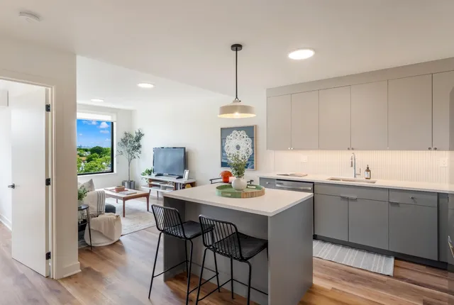 a kitchen with a sink cabinets and wooden floor