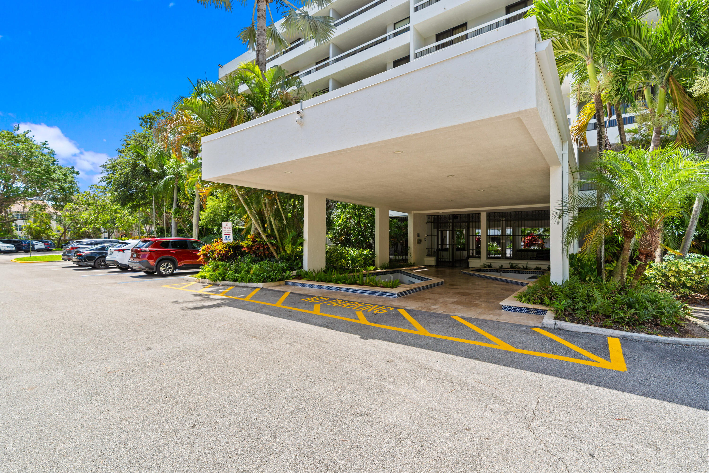 23200 Camino Del Mar, Unit 603 Boca Raton, FL 33433 - Photo 32 of 43 a view of pool with umbrella and car parked