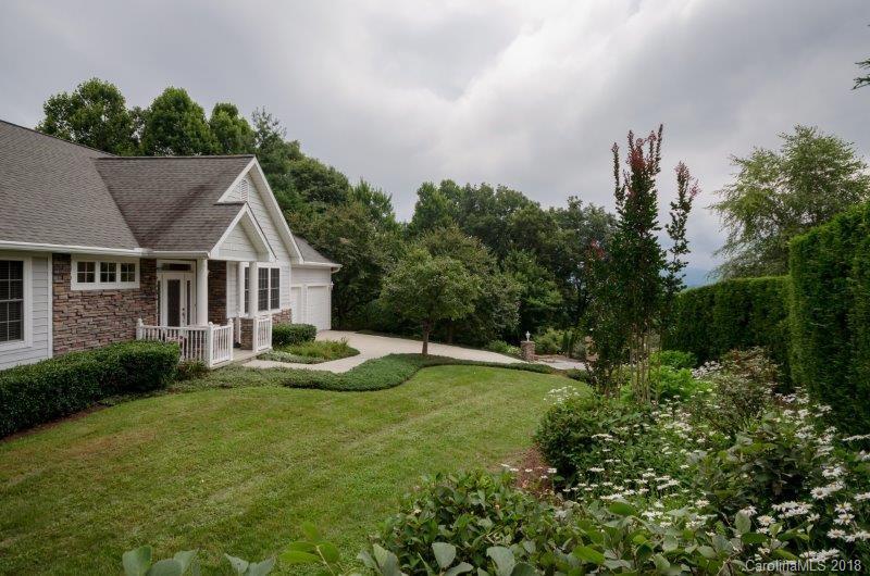 105 Spring Path, Unit 77 Hendersonville, NC 28739 - Photo 2 of 21 a view of a house with backyard and sitting area