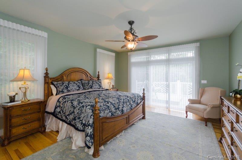 105 Spring Path, Unit 77 Hendersonville, NC 28739 - Photo 12 of 21 a bedroom with a bed and a large window