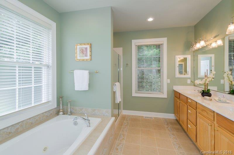 105 Spring Path, Unit 77 Hendersonville, NC 28739 - Photo 13 of 21 a spacious bathroom with a tub sink and mirror