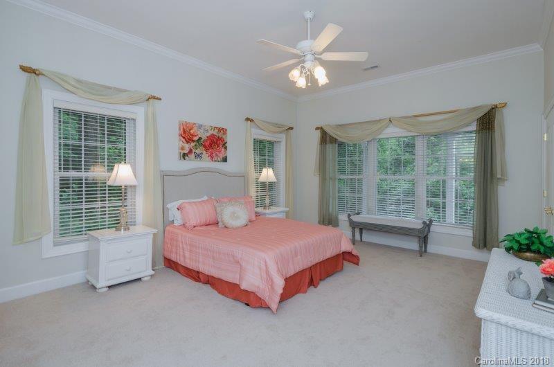 105 Spring Path, Unit 77 Hendersonville, NC 28739 - Photo 18 of 21 a bedroom with a bed and a large window