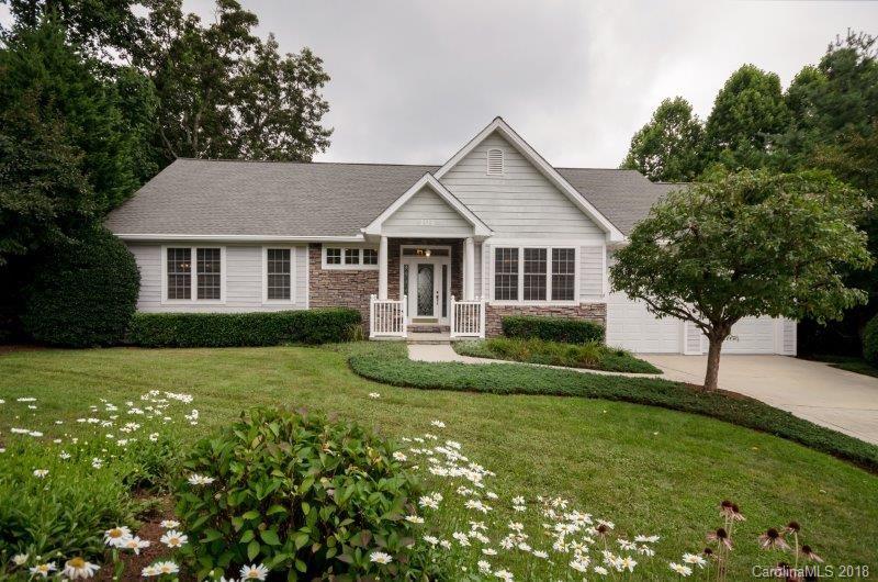 105 Spring Path, Unit 77 Hendersonville, NC 28739 - Photo 3 of 21 a front view of a house with a yard