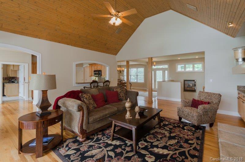 105 Spring Path, Unit 77 Hendersonville, NC 28739 - Photo 4 of 21 a living room with furniture and wooden floor