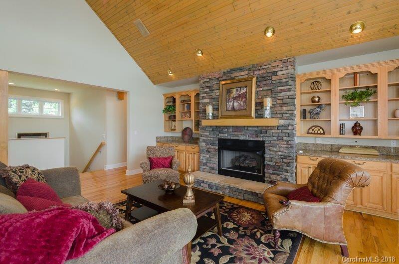 105 Spring Path, Unit 77 Hendersonville, NC 28739 - Photo 6 of 21 a living room with furniture and a fireplace