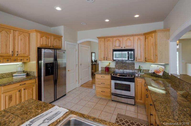 105 Spring Path, Unit 77 Hendersonville, NC 28739 - Photo 8 of 21 a kitchen with a stove a refrigerator and a sink