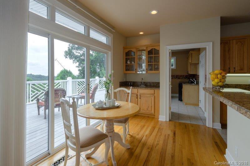 105 Spring Path, Unit 77 Hendersonville, NC 28739 - Photo 10 of 21 a kitchen with a table and chairs in it
