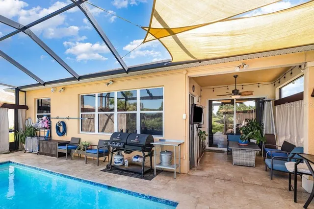 a view of a room with furniture and floor to ceiling window