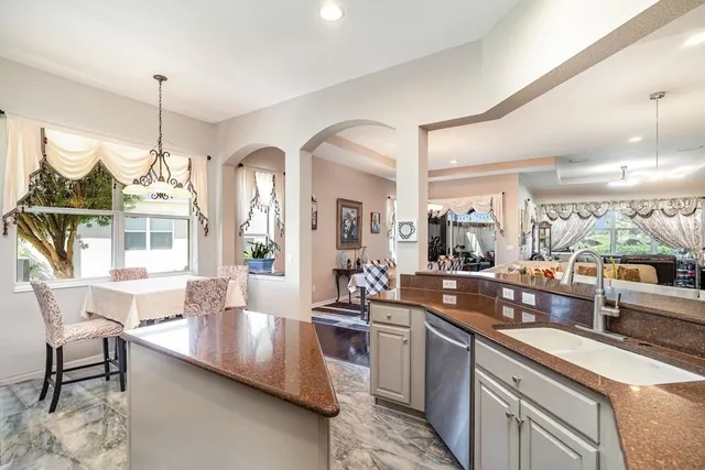a large kitchen with a large window and stainless steel appliances