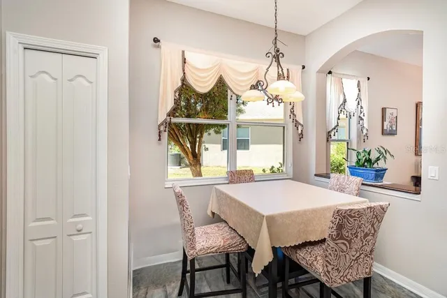 a view of a dining room with furniture and window