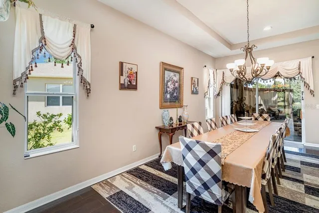 a view of a dining room with furniture and chandelier
