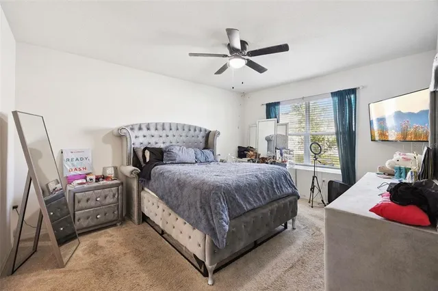 a bedroom with a bed a couch and dresser