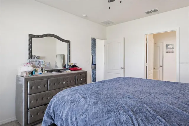 a bed room with a bed and a mirror