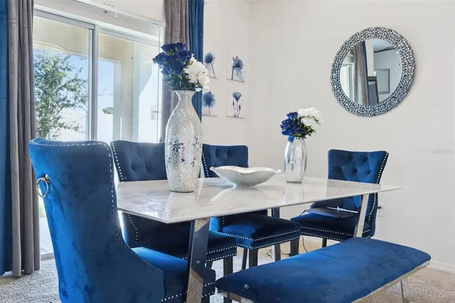 a view of a dining room with furniture and chandelier