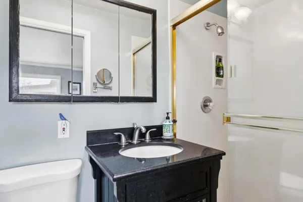 a bedroom with a bed and a large mirror