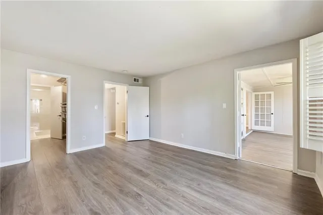 a view of an empty room with wooden floor
